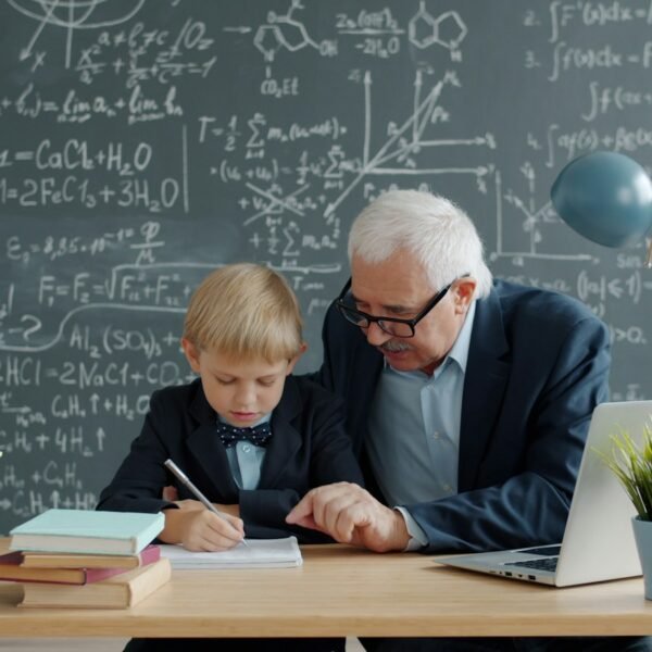 Elderly teacher helps young student with math