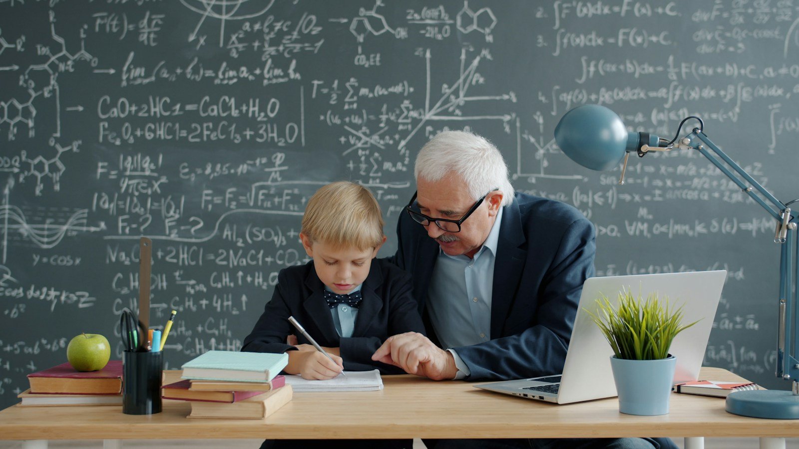 Elderly teacher helps young student with math